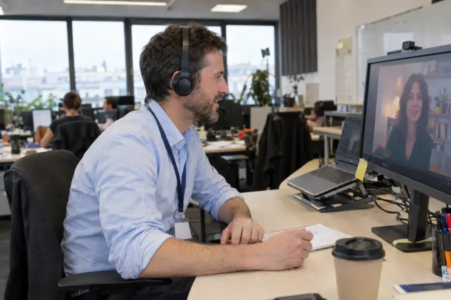 Professional taking a business Spanish lesson by video call at the office